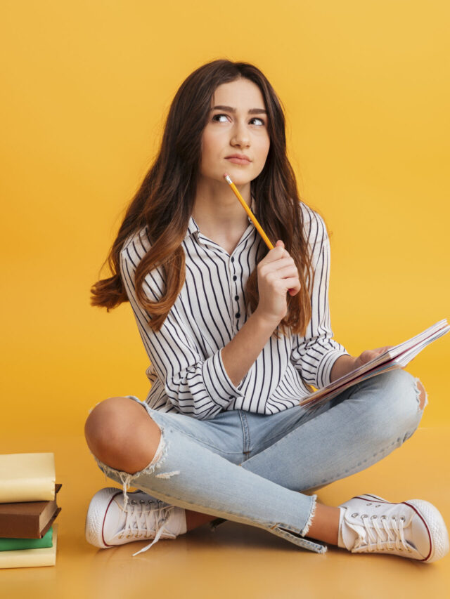 Portrait of a pensive young girl making notes