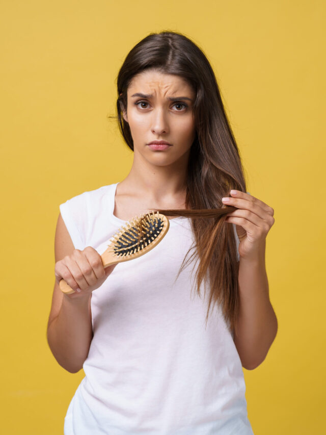 Woman hand holding her long hair with looking at damaged splitting ends of hair care problems.