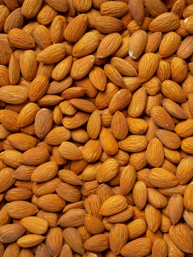 Fresh organic almonds on dark background